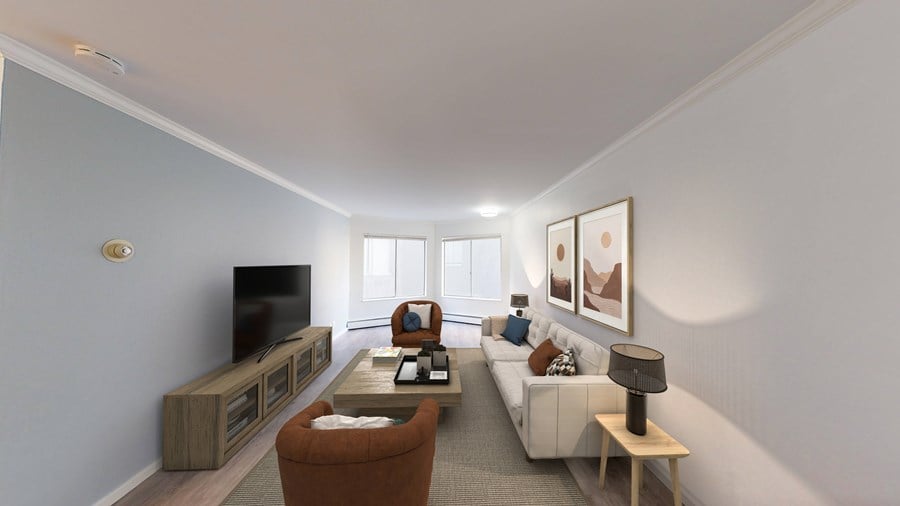 A living room with a white couch, a brown armchair, a wooden coffee table, and a flat-screen TV.